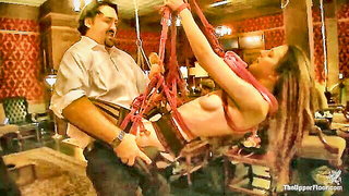 Stefanos suspends brunette in red ropes kink sex video