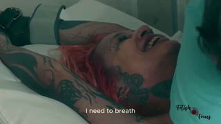 Tattooed redhead restrained by nurse BDSM porn video